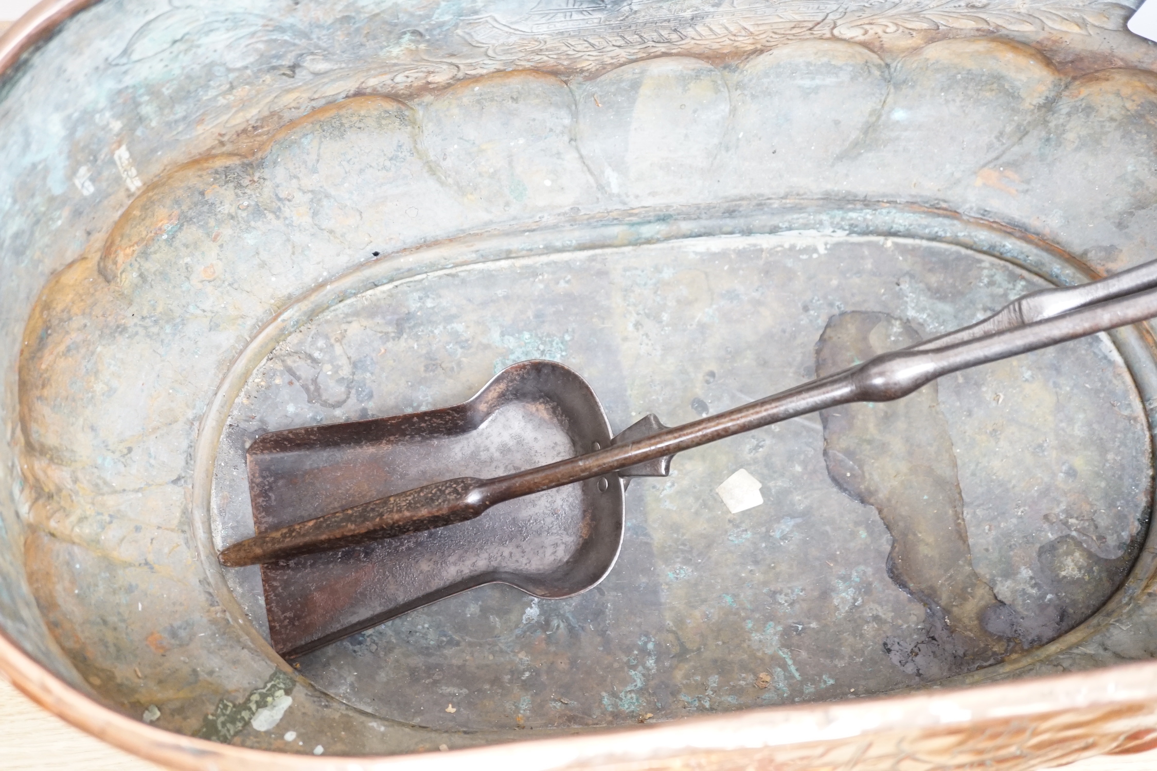 An 18th century Dutch beaten copper planter of elongated form with lion mask handles, beaten ship decoration and heavy gadrooning, 62cm long (Provenance Bonhams Chester 31/10/03). A large 19th century copper jug, baluste